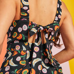 Tie-back detail on black novelty fruit print jumpsuit