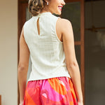Back view showing keyhole button closure on cream top