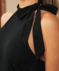 Close-up of black halter neckline with adjustable shoulder tie bow