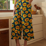 Navy wide-leg palazzo pants with sunflower print styled with matching sleeveless top front view