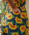 Close-up of sunflower print fabric with functional side pocket detail