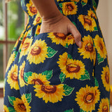 Close-up of sunflower print fabric with functional side pocket detail