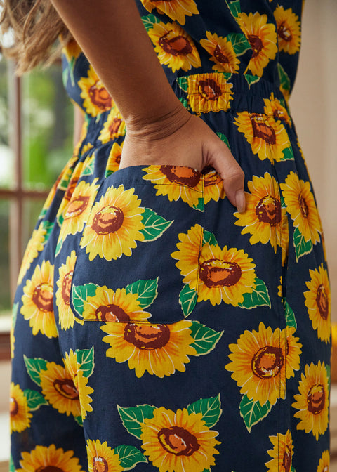 Close-up of sunflower print fabric with functional side pocket detail