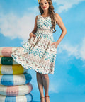 Woman twirling in vintage-inspired fit-and-flare dress with full skirt