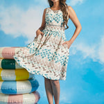 Woman twirling in vintage-inspired fit-and-flare dress with full skirt