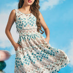 Woman posing in sleeveless coastal-inspired fit-and-flare dress