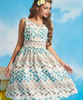 Woman wearing sleeveless novelty fish and bird print fit-and-flare dress