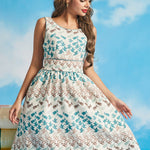 Woman wearing sleeveless novelty fish and bird print fit-and-flare dress