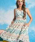 Woman wearing a nautical fish print dress against a blue sky background