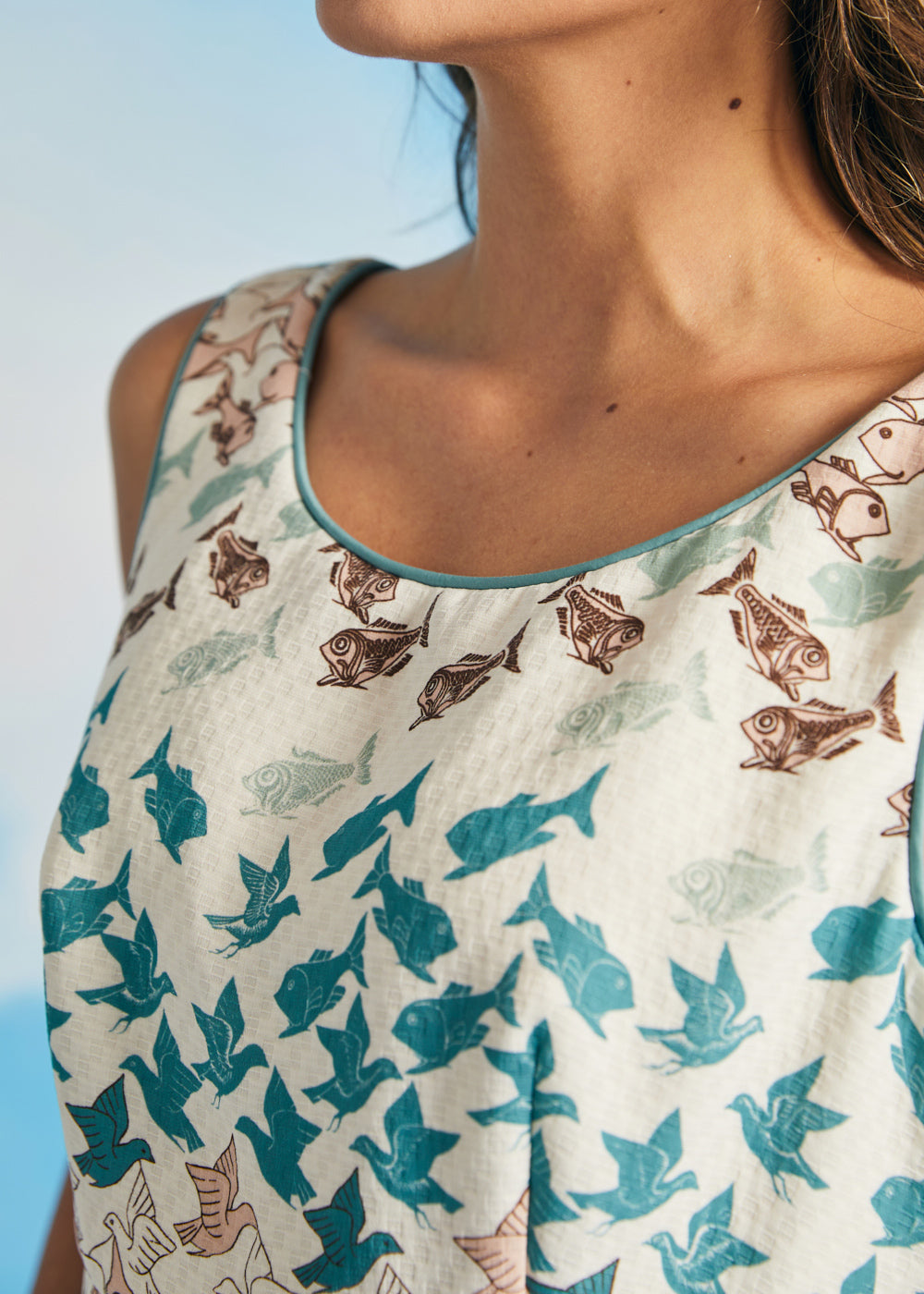 Close-up of rounded neckline with contrast piping on novelty print dress