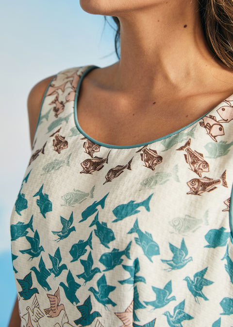 Close-up of rounded neckline with contrast piping on novelty print dress