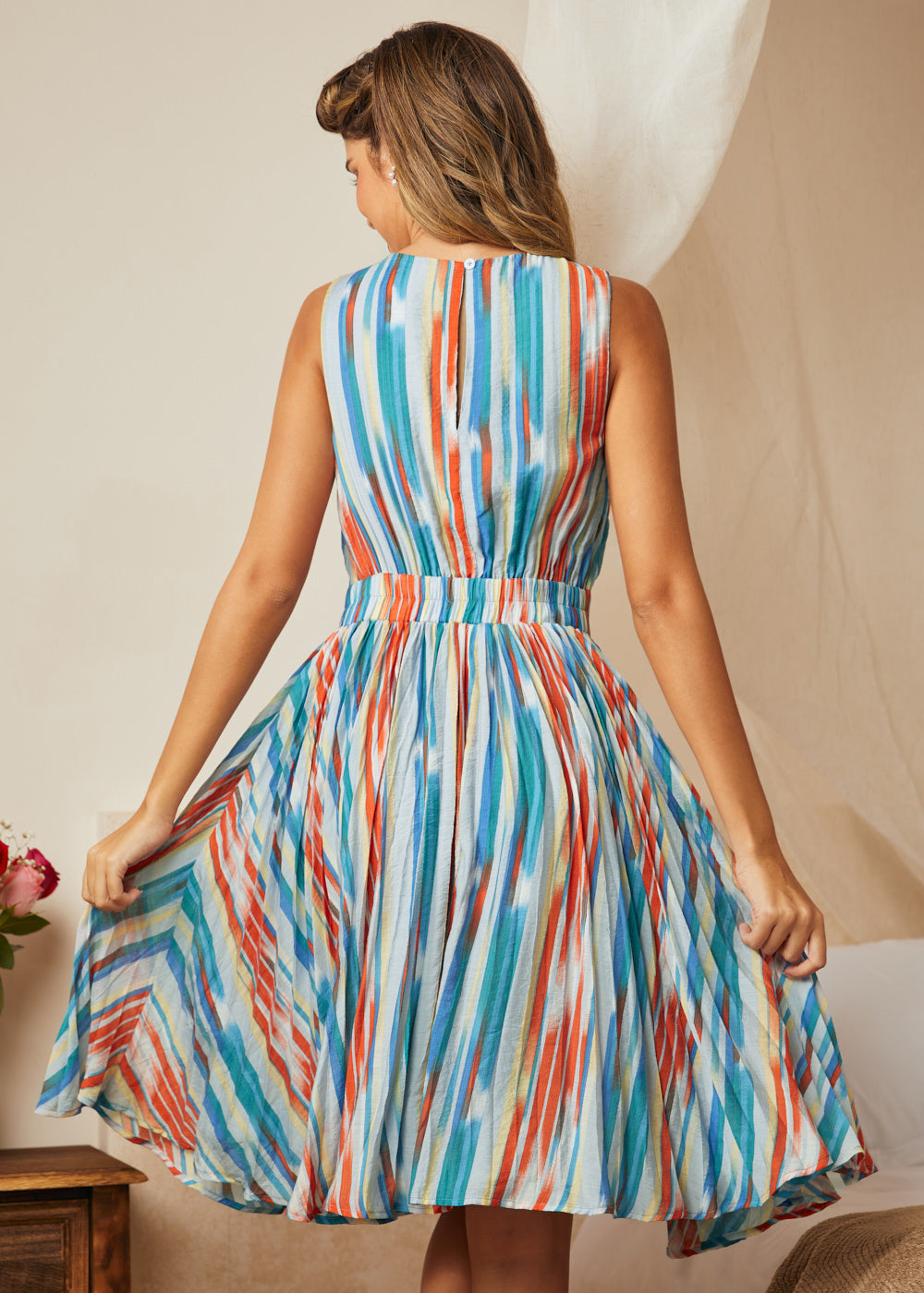 Back view of multicolor stripe dress with gathered skirt and keyhole closure