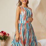 Woman wearing sleeveless striped dress with fit and flare shape