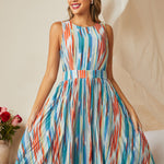 Woman wearing colorful striped midi dress with vintage-inspired silhouette