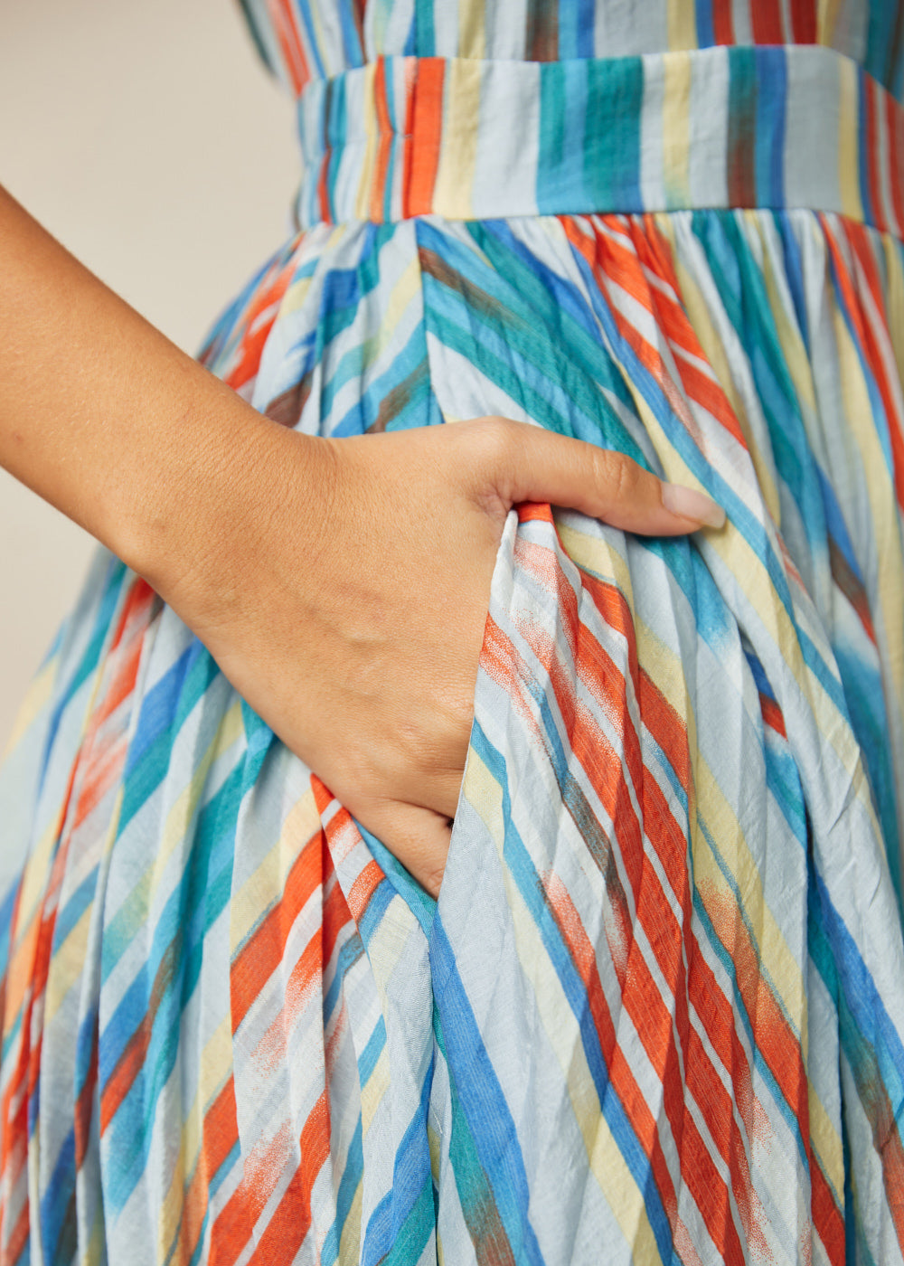 Close-up of functional side pocket on multicolor striped dress