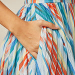 Close-up of functional side pocket on multicolor striped dress