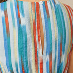 Close-up back detail of striped dress with button keyhole closure
