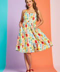 Woman wearing vintage-inspired watercolor patchwork sundress with square neckline and full skirt