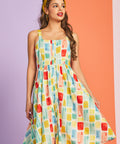 Woman modeling pastel watercolor print sundress with square neckline and button-front design