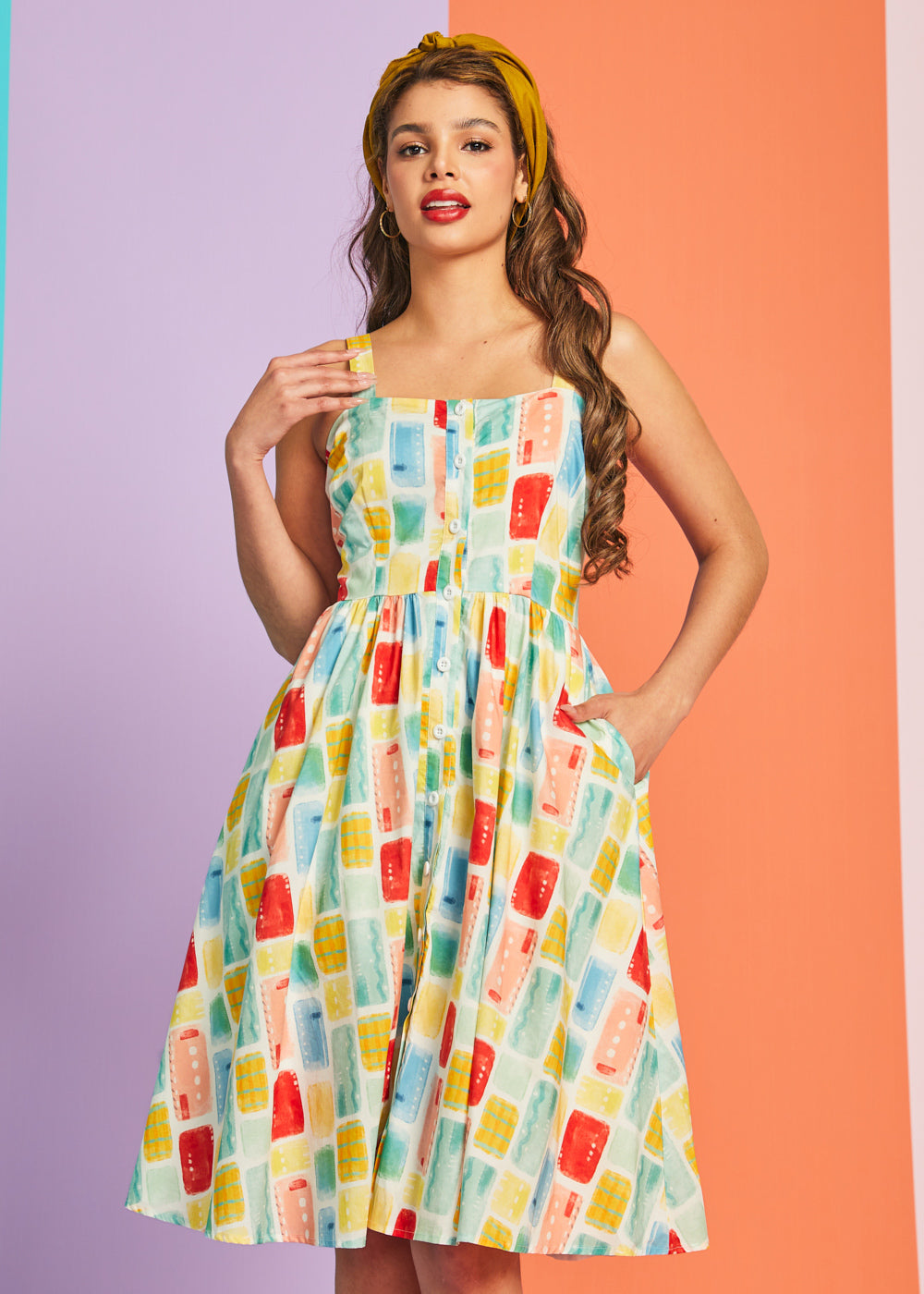 Woman wearing vintage-style cotton sundress with gathered waist and full skirt