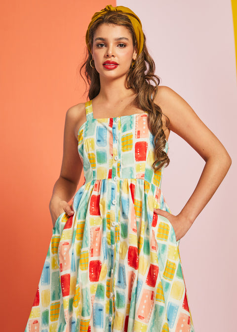 Woman modeling vintage-inspired cotton sundress in Painted Picnic print with pockets