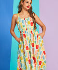 Woman modeling sleeveless cotton sundress with button-front detail and swing silhouette
