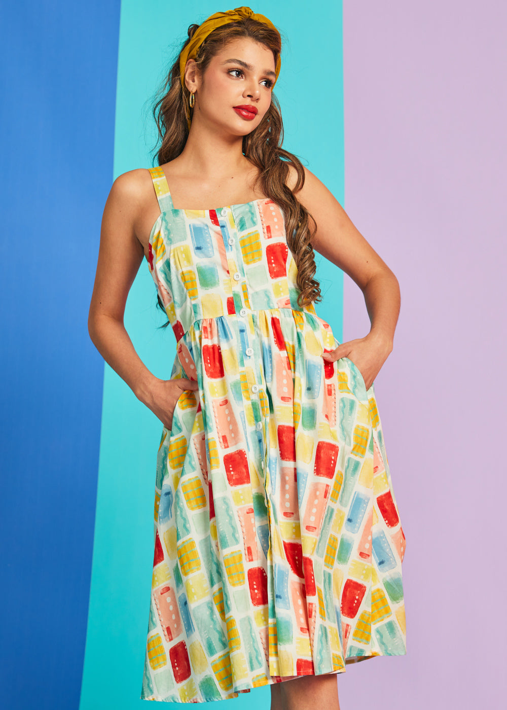 Woman modeling sleeveless cotton sundress with button-front detail and swing silhouette