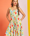 Woman wearing colorful retro sundress with wide straps and breezy silhouette