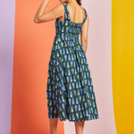 Back view of teal novelty print midi dress with smocked back panel