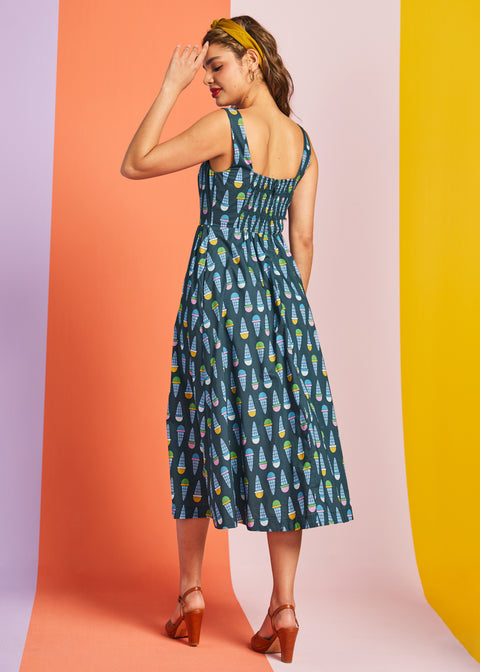 Back view of teal novelty print midi dress with smocked back panel