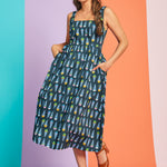 Woman posing in retro cotton sundress with colorful ice cream print