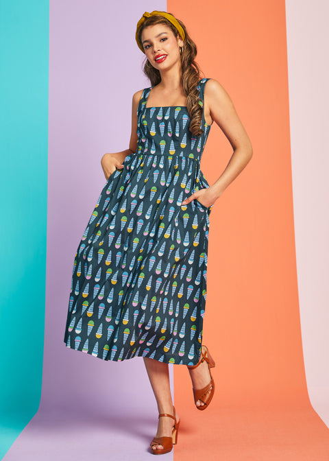 Woman posing in retro cotton sundress with colorful ice cream print