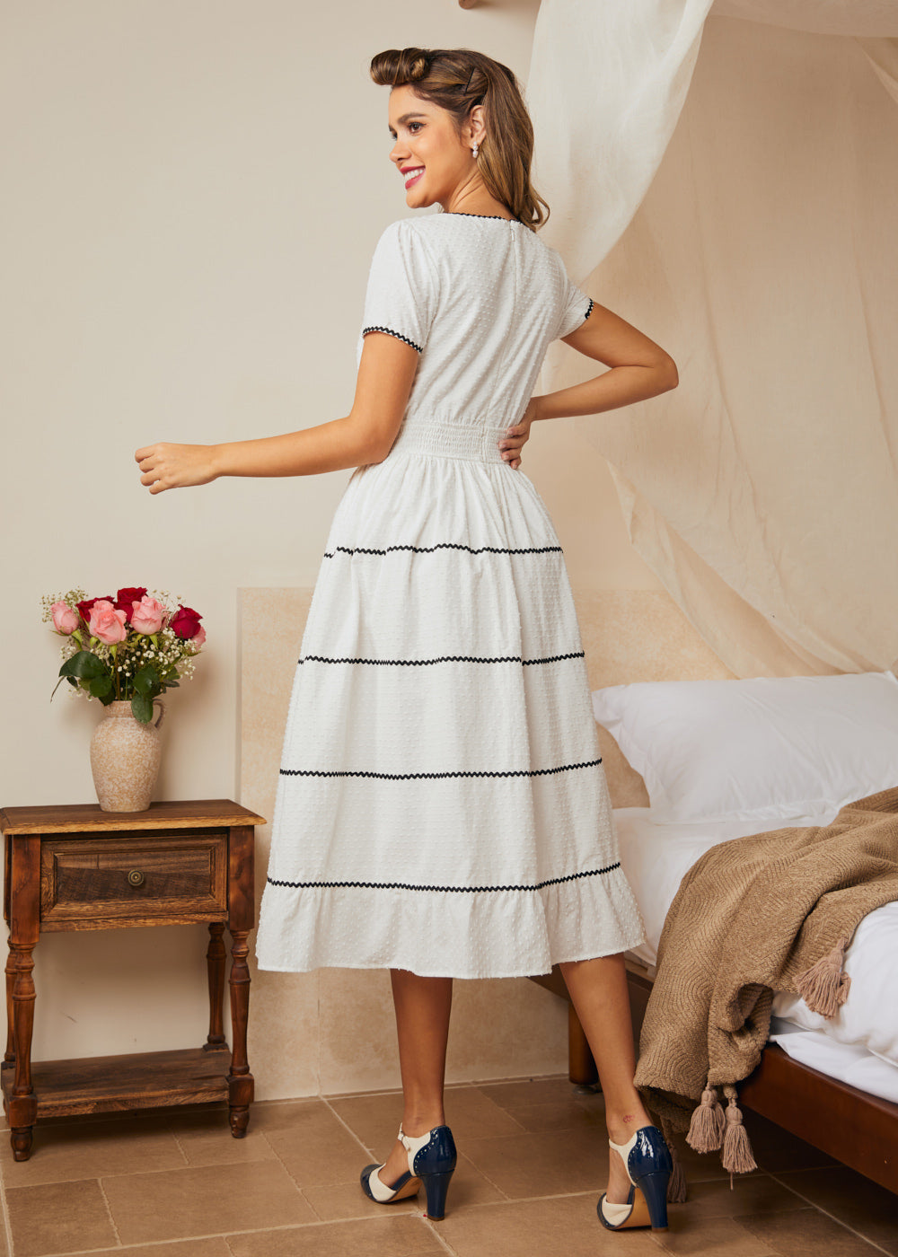 Back view of midi dress with smocked waist and full skirt