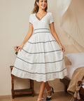 Full-length view of white fit-and-flare dress styled with vintage-inspired heels