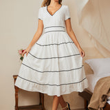 Full-length view of white fit-and-flare dress styled with vintage-inspired heels