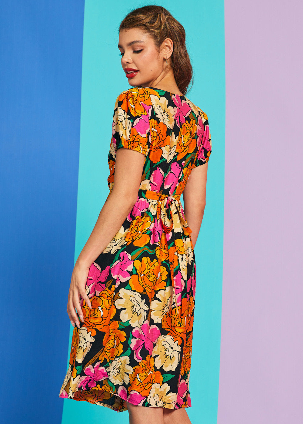 Side angle of retro floral print summer dress with puff sleeves and pockets