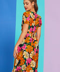 Side angle of retro floral print summer dress with puff sleeves and pockets