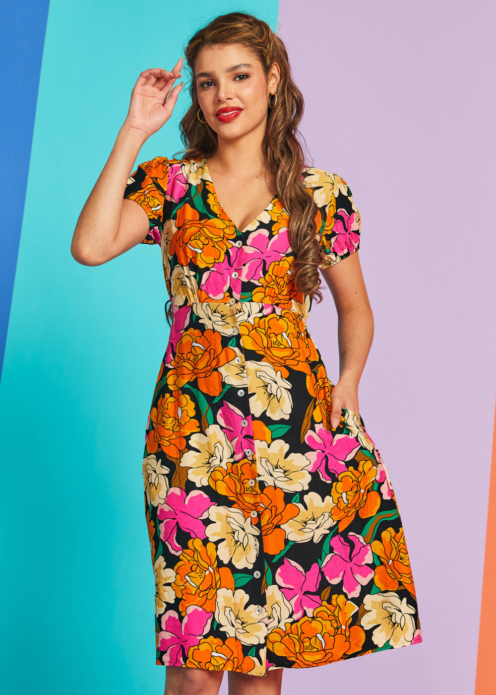 Woman wearing vintage-inspired floral button-front midi dress with pockets
