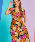 Woman wearing vintage-inspired floral button-front midi dress with pockets