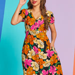 Woman wearing vintage-inspired floral button-front midi dress with pockets