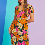 Woman wearing retro mod floral puff sleeve midi dress with v-neckline