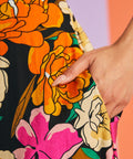 Hand in pocket detail of retro floral summer midi dress