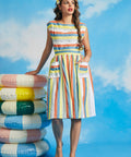 Woman wearing retro pastel stripe midi skirt with oversized patch pockets and full silhouette