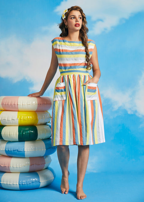 Woman wearing retro pastel stripe midi skirt with oversized patch pockets and full silhouette
