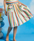 Woman twirling in retro-inspired multicolor stripe dirndl skirt with full gathered silhouette