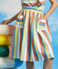 Close-up of vintage-style striped skirt with oversized pockets and gathered waist detail