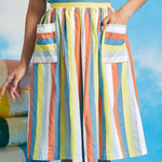 Woman wearing vintage-inspired pastel stripe dirndl skirt with oversized patch pockets and sleeveless striped top