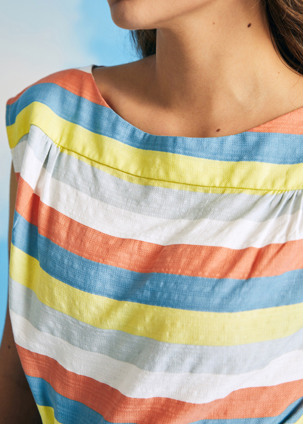 Close-up of vintage-inspired pastel stripe woven top with boat neckline and cap sleeves