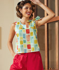 Sleeveless blouse with colorful abstract print and shoulder bow detail front view
