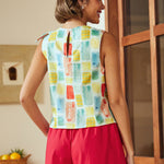 Back view of sleeveless blouse with keyhole button closure